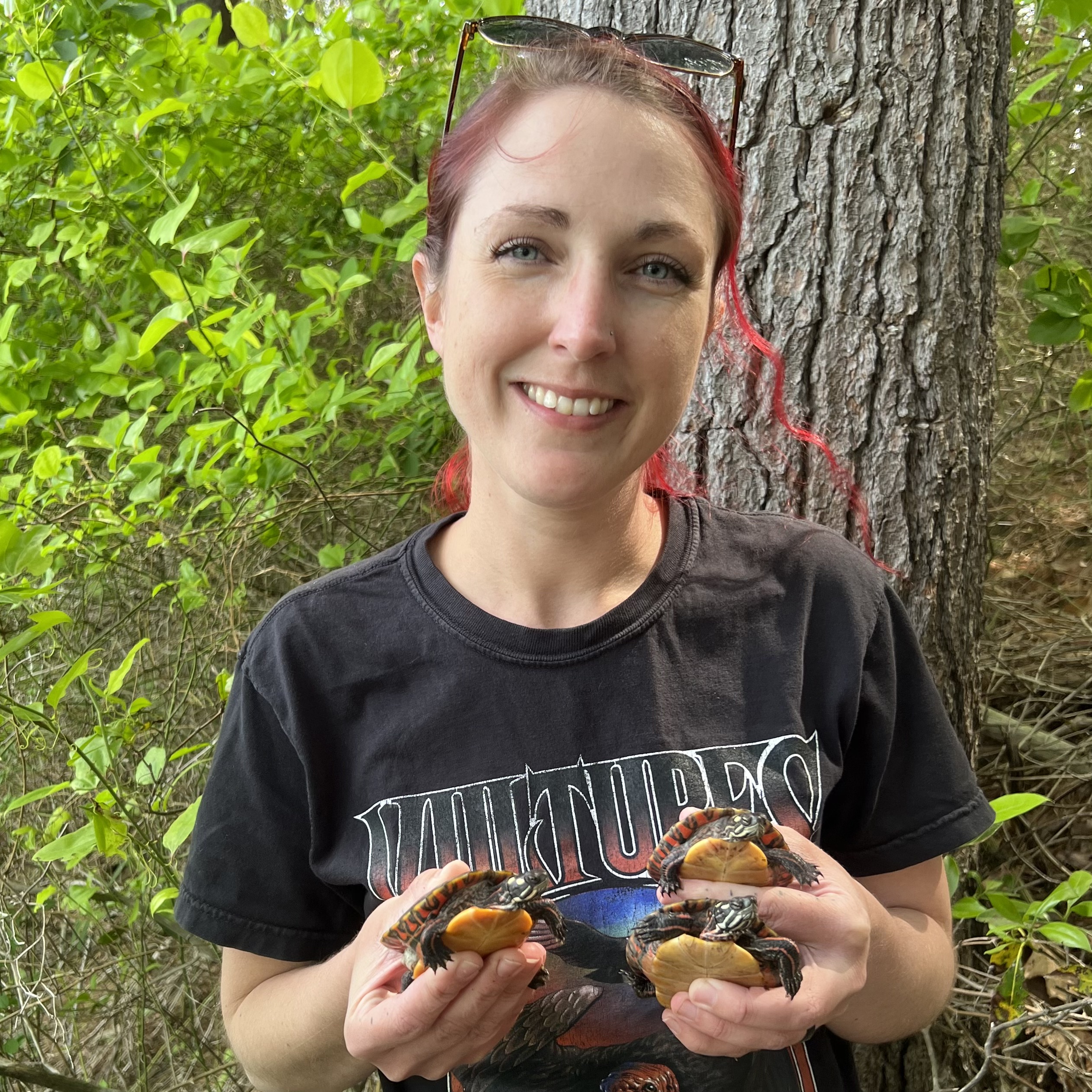 Dallas Huggins with painted turtles during a release.